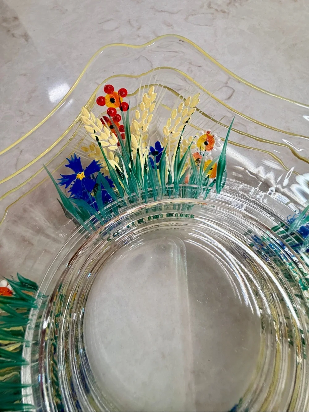 7 1/4” CLEAR GLASS PLATES WITH A COLORFUL, HAND-PAINTED DESIGN & YELLOW TRIM.